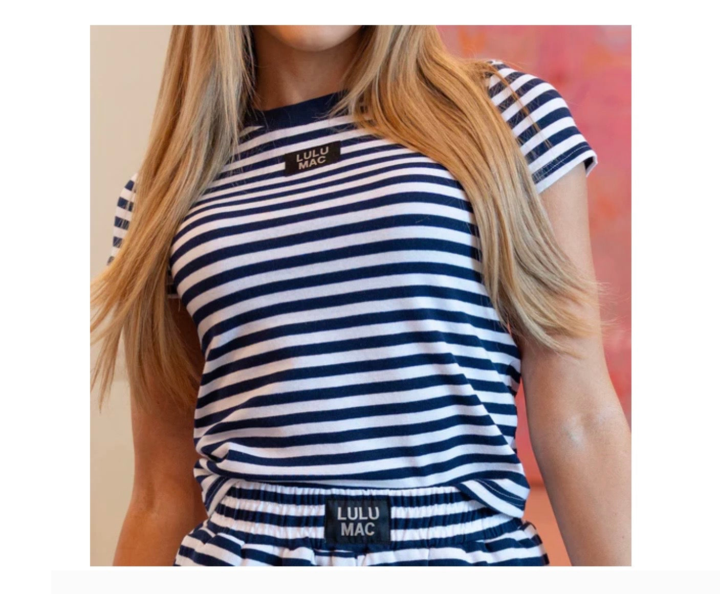 Navy and white striped top with 'LULU MAC' branding worn by a person.