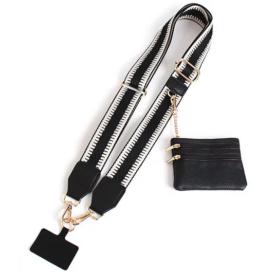 Black bag strap with gold hardware and a small black pouch on a white background