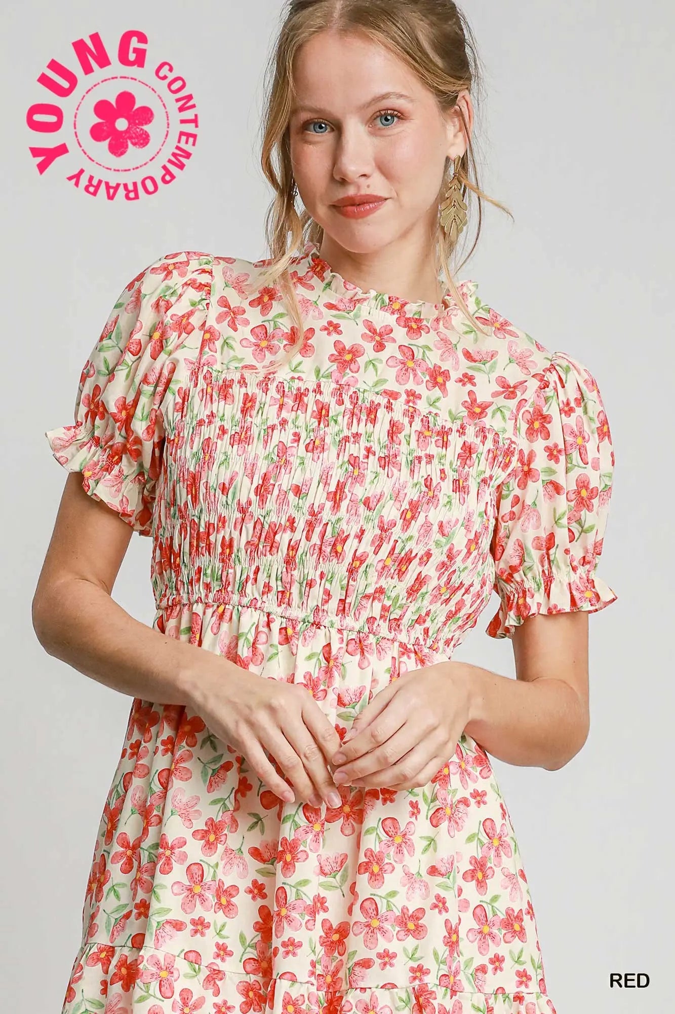 Woman wearing a floral dress with 'Young Contemporary' branding on a light gray background