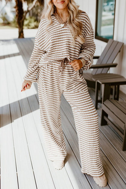 Woman wearing a striped outfit on a wooden deck