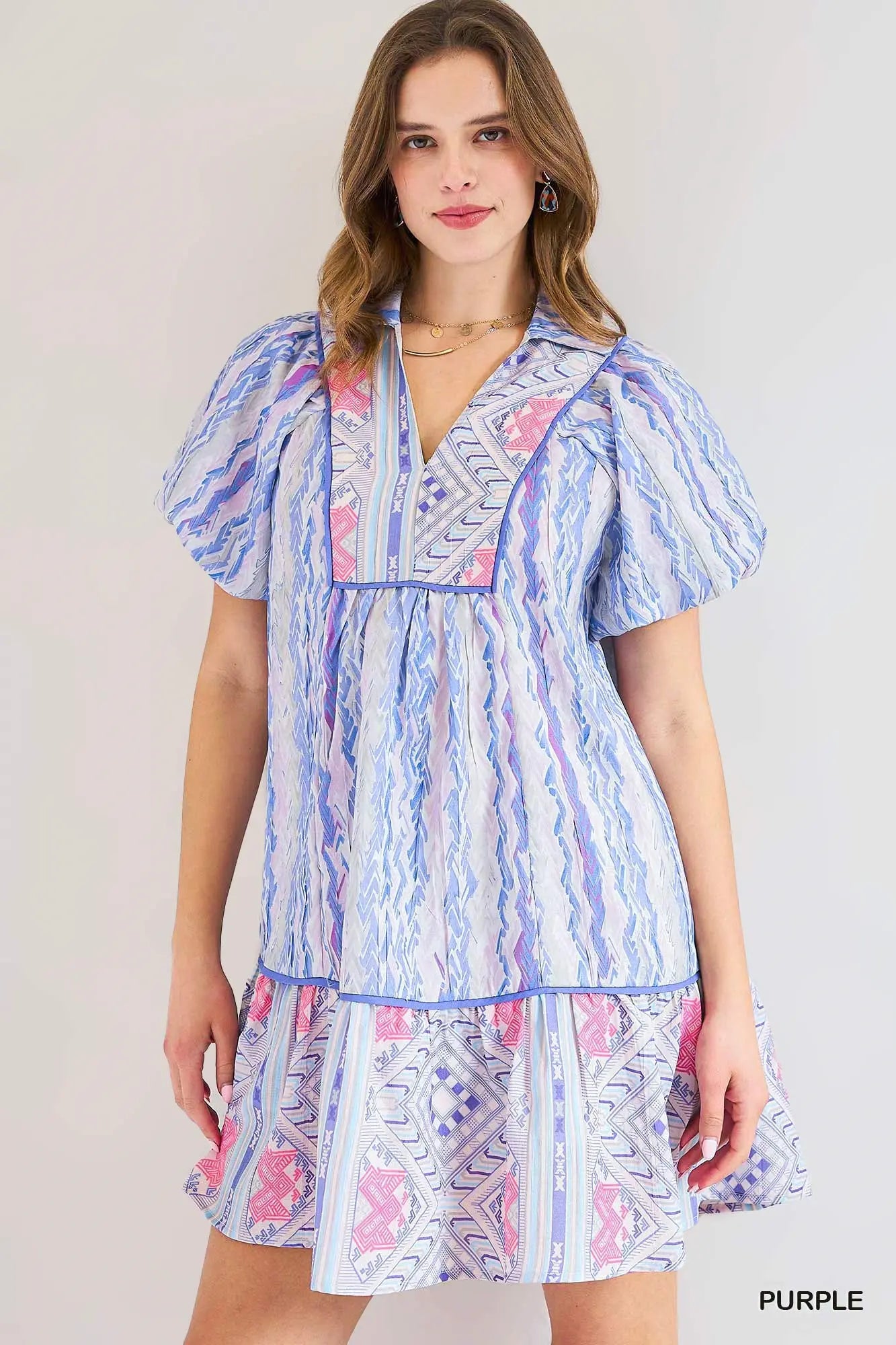 Woman wearing a colorful dress with a white background