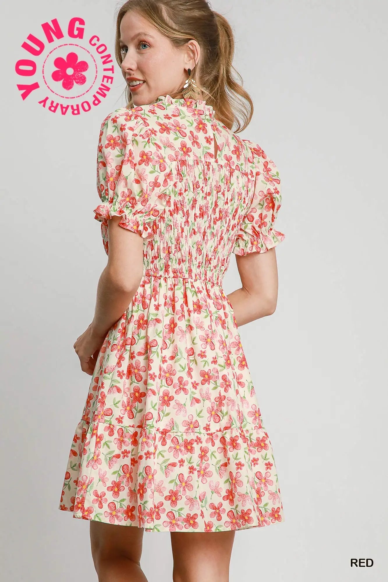 Woman wearing a floral dress with 'Young Contemporary' branding on a gray background