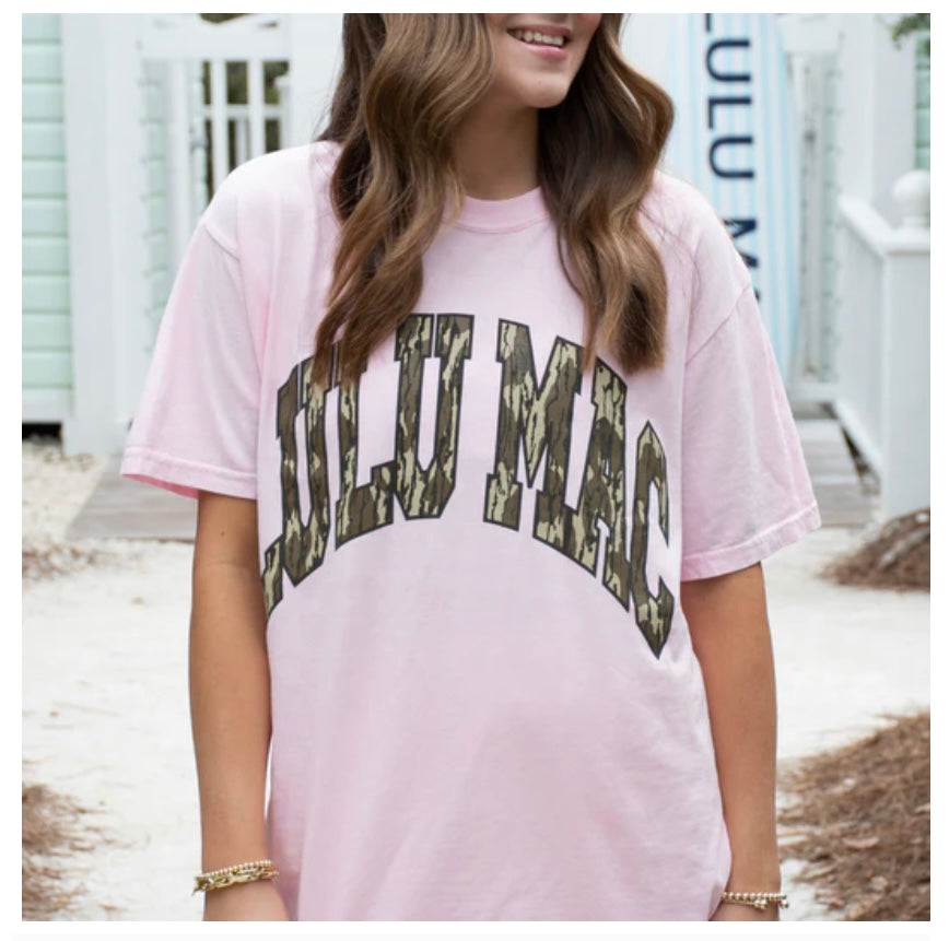Person wearing a pink t-shirt with 'FULL MOON' printed in camouflage text.