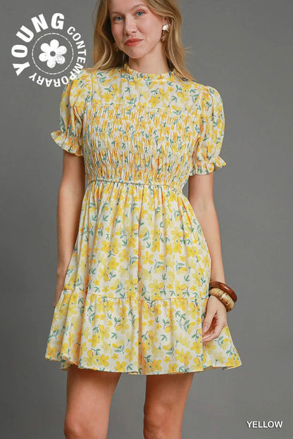 Woman wearing a yellow floral dress with 'Young Contemporary' branding on a gray background