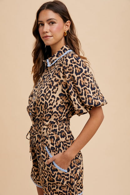 Woman wearing a leopard print dress with a beige background