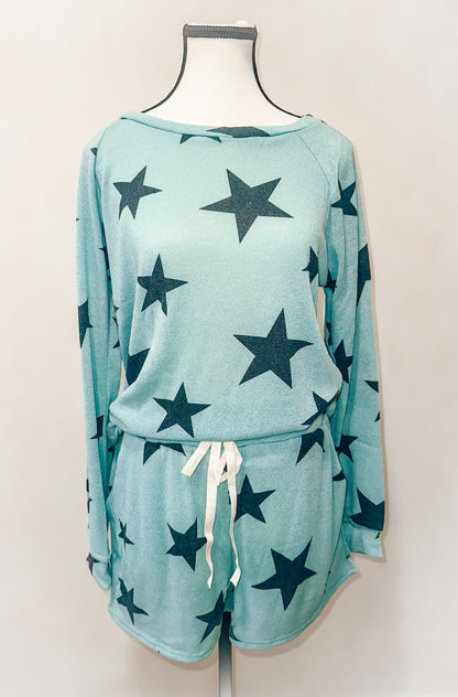 A two-piece lounge set consisting of a star-patterned long-sleeve top and shorts with a drawstring, displayed on a mannequin against a plain background.